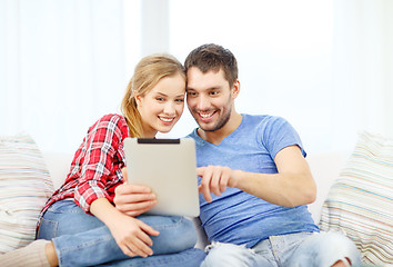 Image showing smiling couple with tablet pc computer at home