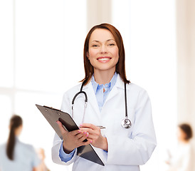 Image showing smiling female doctor with clipboard