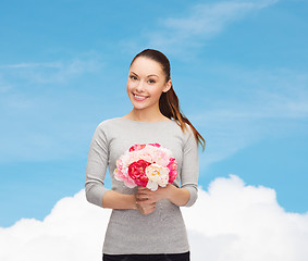 Image showing young woman with bouquet of flowers