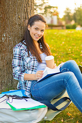 Image showing teenager reading book with take away coffee