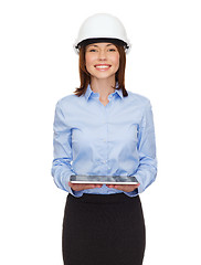 Image showing young businesswoman in white helmet with tablet pc