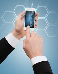 Image showing businessman touching screen of smartphone