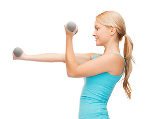 Image showing young sporty woman with light dumbbells