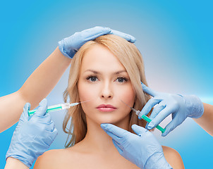 Image showing woman face and beautician hands with syringes