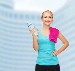 Image showing sporty woman with towel and watel bottle