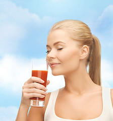 Image showing young woman drinking tomato juice