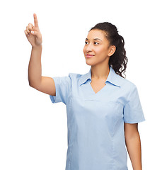 Image showing smiling doctor or nurse pointing to something