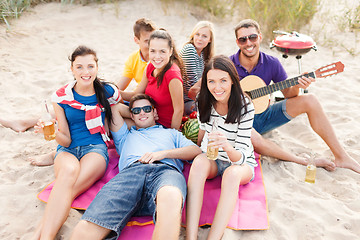 Image showing group of friends with guitar having fun on beach