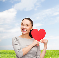 Image showing smiling asian woman with red heart