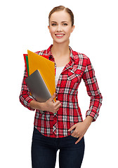 Image showing smiling student with folders and tablet pc