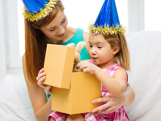 Image showing mother and daughter in blue hats with favor horns