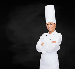 Image showing smiling female chef with crossed arms