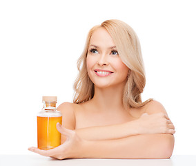 Image showing happy woman with oil bottle