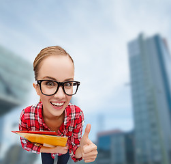 Image showing student in glasses with folders showing thumbs up