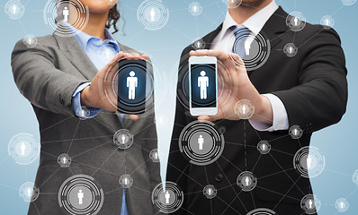 Image showing businessman and businesswoman with smartphones