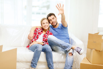 Image showing smiling couple relaxing on sofa in new home