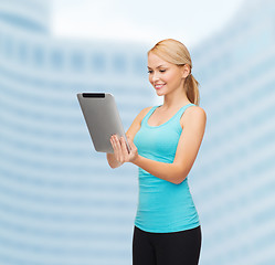 Image showing sporty woman with tablet pc