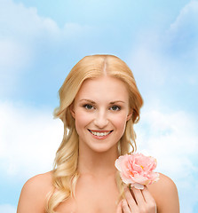 Image showing smiling woman with peony flower