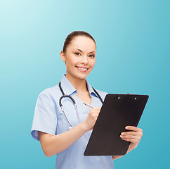 Image showing smiling female doctor or nurse with stethoscope