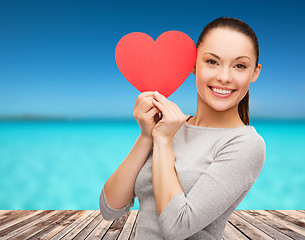 Image showing smiling asian woman with red heart