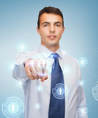 Image showing buisnessman pointing finger to virtual screen