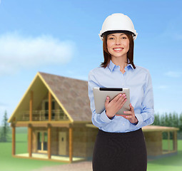 Image showing young smiling businesswoman in white helmet