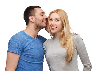 Image showing smiling boyfriend telling girlfriend secret