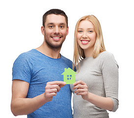 Image showing smiling couple holding green paper house