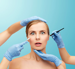 Image showing woman face and beautician hands with pencil