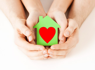 Image showing couple hands holding green paper house