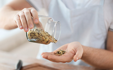 Image showing male emptying jar with white and wild black rice