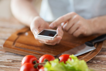 Image showing closeup of man pointing finger to smartphone