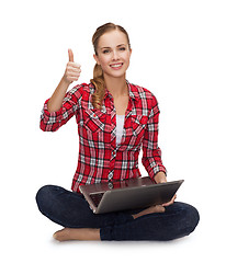 Image showing young girl sitting on the floor with laptop