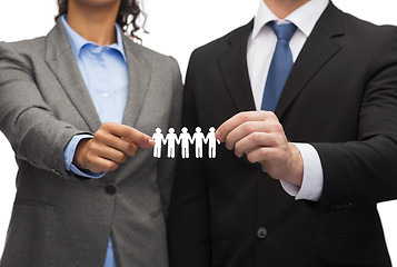 Image showing businessman and businesswoman holding paper team