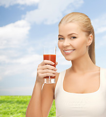 Image showing smiling woman holding glass of tomato juice