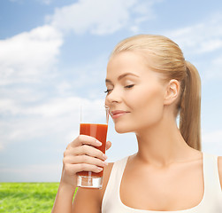 Image showing young woman drinking tomato juice