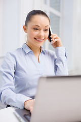 Image showing smiling businesswoman with laptop