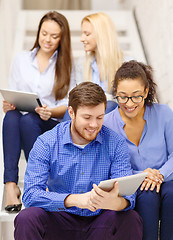 Image showing team with tablet pc computer sitting on staircase