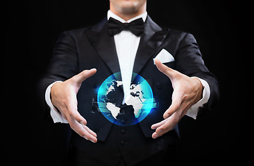 Image showing magician in top hat showing globe hologram