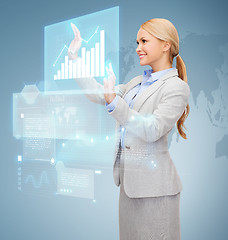 Image showing smiling businesswoman working with virtual screen