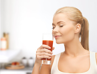 Image showing young woman drinking tomato juice