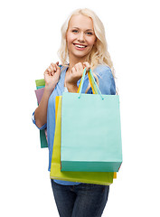 Image showing smiling woman with many shopping bags