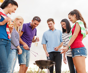 Image showing group of friends making barbecue on the beach