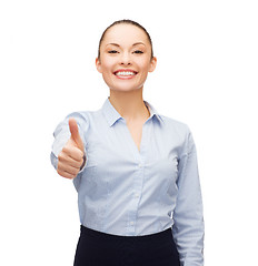 Image showing young smiling businesswoman showing thumbs up