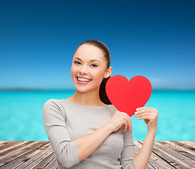 Image showing smiling asian woman with red heart