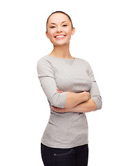 Image showing smiling asian woman over with crossed arms