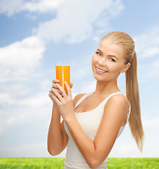 Image showing woman holding glass of orange juice