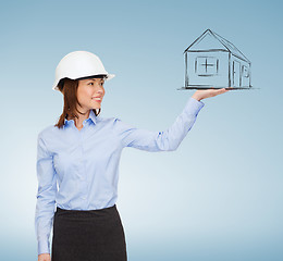 Image showing young smiling businesswoman in white helmet