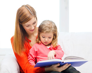 Image showing happy mother and daughter with book