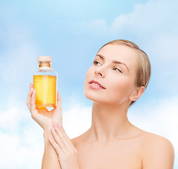 Image showing lovely woman with oil bottle